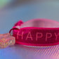 Close-up of 'Happy' text and glitter star charm