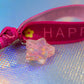 Full view of 'Happy' bracelet with glitter star charm