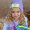 Child wearing the All Smiles & Happy Vibes beanie with smiley patches