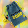 Full view of the denim Allo Maman Bobo first aid kit pouch with yellow drawstrings and smiley tag