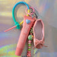 Close-up of the Ballerina Key Charm showing pink ballet shoe, heart clip, and lip balm charm