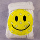 Cotton white kids bathrobe with yellow bandana smiley patch folded neatly