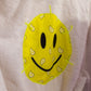 Yellow smiley face patch stitched on back of white cotton kids bathrobe