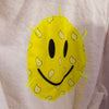 Yellow smiley face patch stitched on back of white cotton kids bathrobe