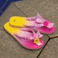 pink bandana flip flops with smiley charm on tiled floor