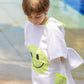 Close-up of the Bandana Smiley Poncho cotton white with neon green smiley patch