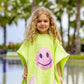 bandana smiley poncho curious lime towel poncho close view showing pink smiley patch