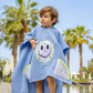 Front view of kids denim blue bandana smiley poncho