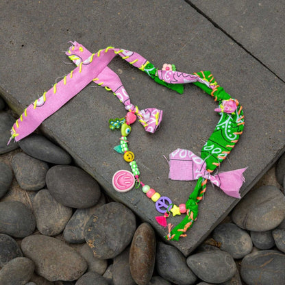 Bandana Twin Bracelet displayed on stone surface with mixed bandana fabric and charms