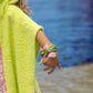 Bandana Twin Bracelet worn on child’s wrist with colourful charms by the pool
