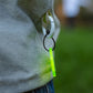 Close-up of the neon smiley keychain attached to the Big Dreamer long sleeves T-shirt