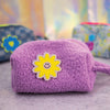 purple boucle puffy pouch with smiley flower patch on front