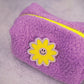 purple boucle puffy pouch with smiley flower patch detail