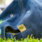 close-up of denim cap back with stitched tag and adjustable strap