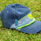 denim cap featuring neon green smiley patch and gamer pin
