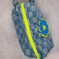 side view of checkered denim pouch with neon yellow zipper