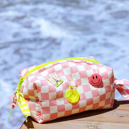 Peony pink checkered puffy pouch with yellow zipper and decorative pins