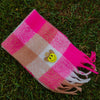 Checkered Wilder Than The West kids scarf in bright pink and sand with smiley pin
