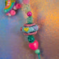 Detail of the middle section, showcasing the large decorative Chunky Bead with embossed hearts and the bright neon pink heart bead below it