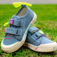 Side view of cool girls denim sneakers featuring cute yellow bow and beaded charms