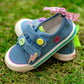Top angle of cool girls denim sneakers decorated with smiley and peace sign charms