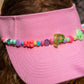 closeup of colourful beaded trim on pink kids visor