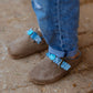 Side view of cool kids bandana slip-on shoes worn with jeans on outdoor surface