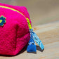 Close-up of zipper pull detail on Curious Bright Pink Towel Puffy cosmetic bag