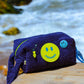 Angled front view of Curious Deep Sea Towel Puffy cosmetic bag with decorative patches