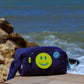 Curious Deep Sea Towel Puffy cosmetic bag displayed outdoors by the seaside