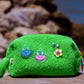 Curious Lime towel puffy cosmetic bag with smiley shaker patches and flower charm