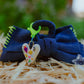 Front view of denim hair clip with hand stitch detail and heart charm