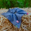 Angle view of denim scrunchie with hand stitch details