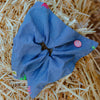 Denim scrunchie with hand stitch details and smiley button