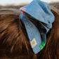 Denim scrunchie with hand stitch details worn in hair