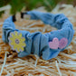 Denim wavy headband with yellow smiley flower and pink heart patches 