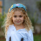 Child wearing denim wavy headband with smiley flower and pink heart patches