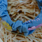 Close-up of pink hand-stitched detail on denim wavy headband