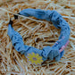 Top view of denim wavy headband with ruched denim and cute patches