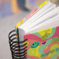 close up of spiral binding and colourful cover of dream smile shine 2026 agenda