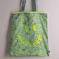Floral Happy Vibes tote bag with neon smiley face design on the front