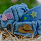 General denim headband featuring heart, smiley, flower, and star charms