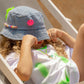 girls denim bucket hat with pink smiley badge and bead details