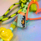 Yellow camera bead and checkered bead detail on peach graffiti heart key charm
