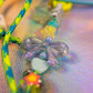 Macro detail of bow and heart beads on sky blue graffiti heart key charm