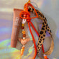 Full Graffiti Leopard Key Charm with leopard-print ribbon, peace charm, and orange beads