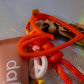 Detail of Graffiti Leopard Key Charm featuring orange heart frame and leopard ribbon