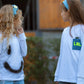 Kids wearing cotton white long sleeve T-shirts with printed smiley and LOL patches outdoors