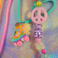 Focus on the playful charms: the pastel pink peace sign, the iridescent purple gummy bear, and the colorful roller skate charm