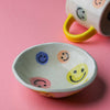 Colourful ceramic happy face bowl with multicolour smiley designs inside and smooth glazed finish